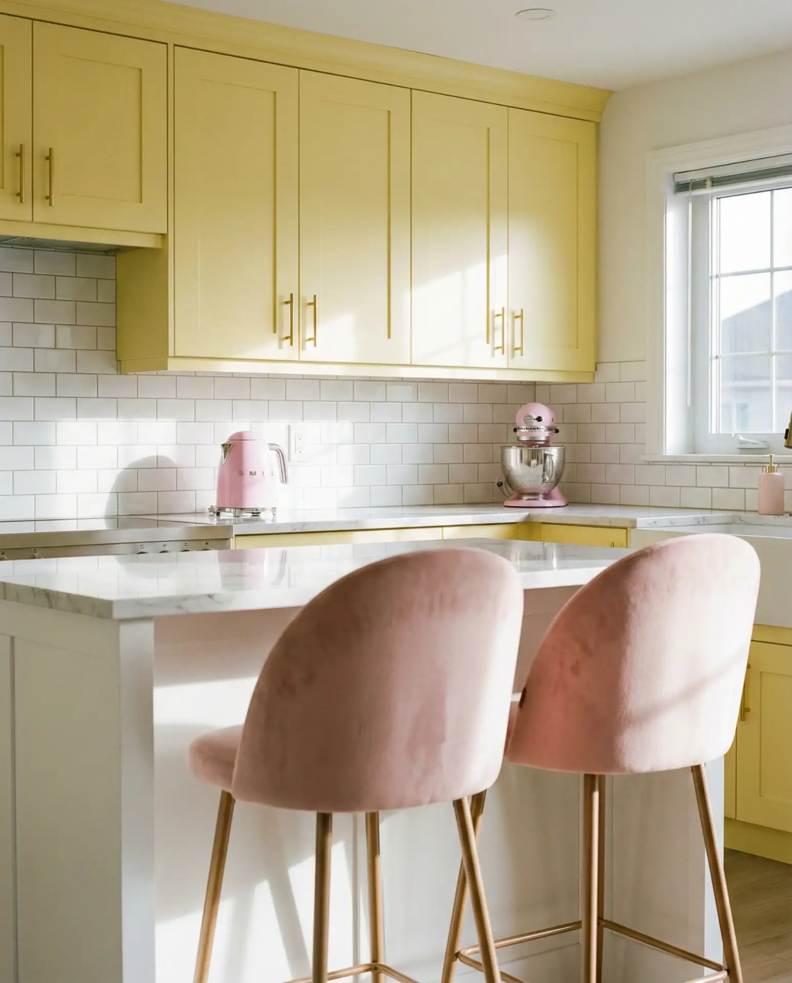 Butter Yellow Cabinets with Marble Countertops 2