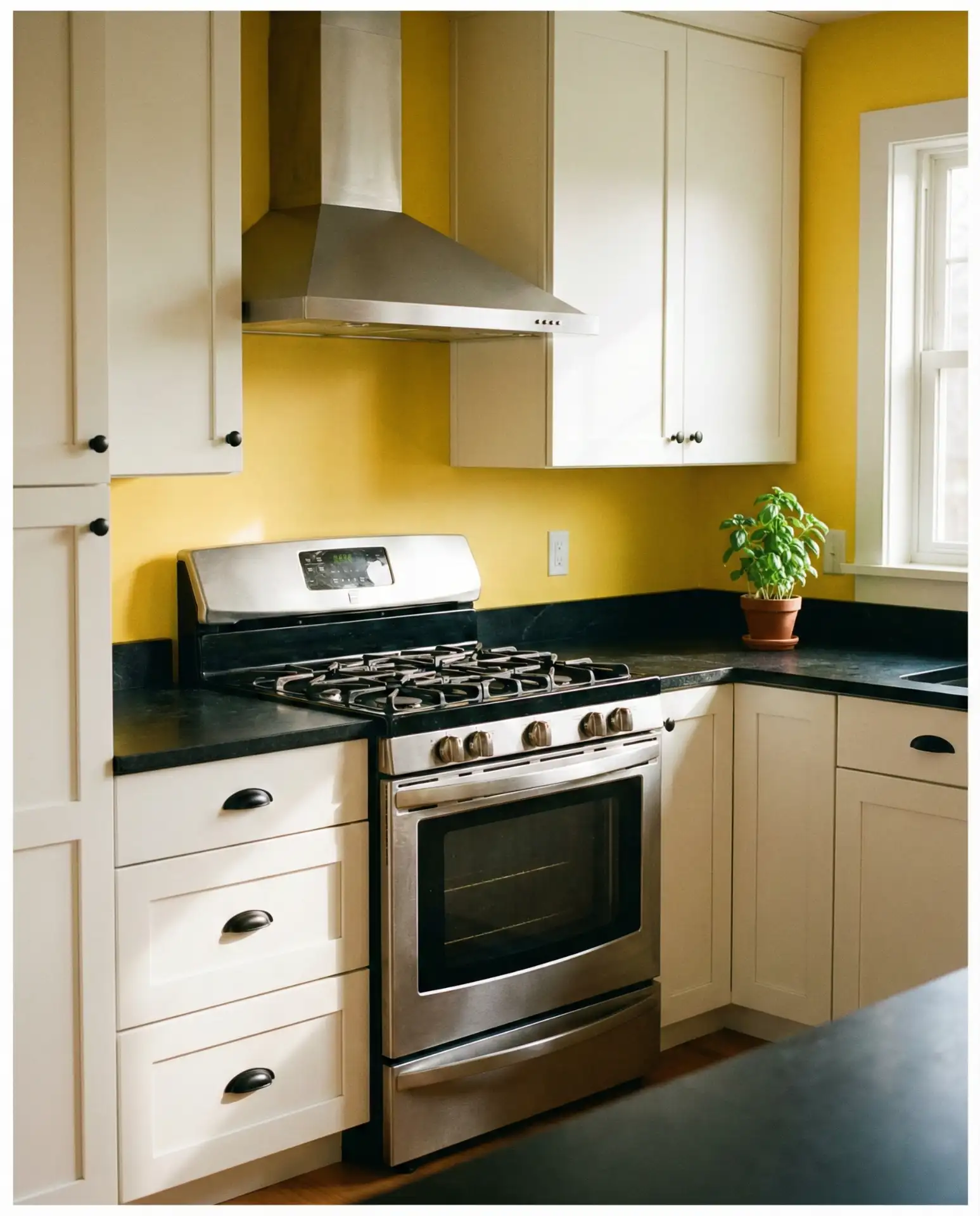 Buttery Yellow Walls with White Cabinets and Black Countertops 2