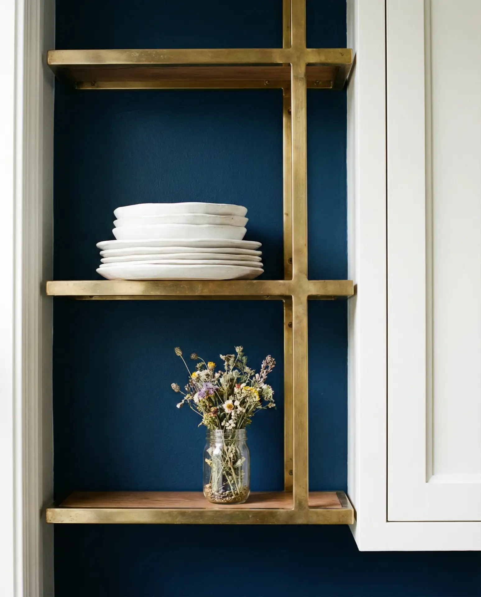 Deep Navy Walls with Brass Accents 1