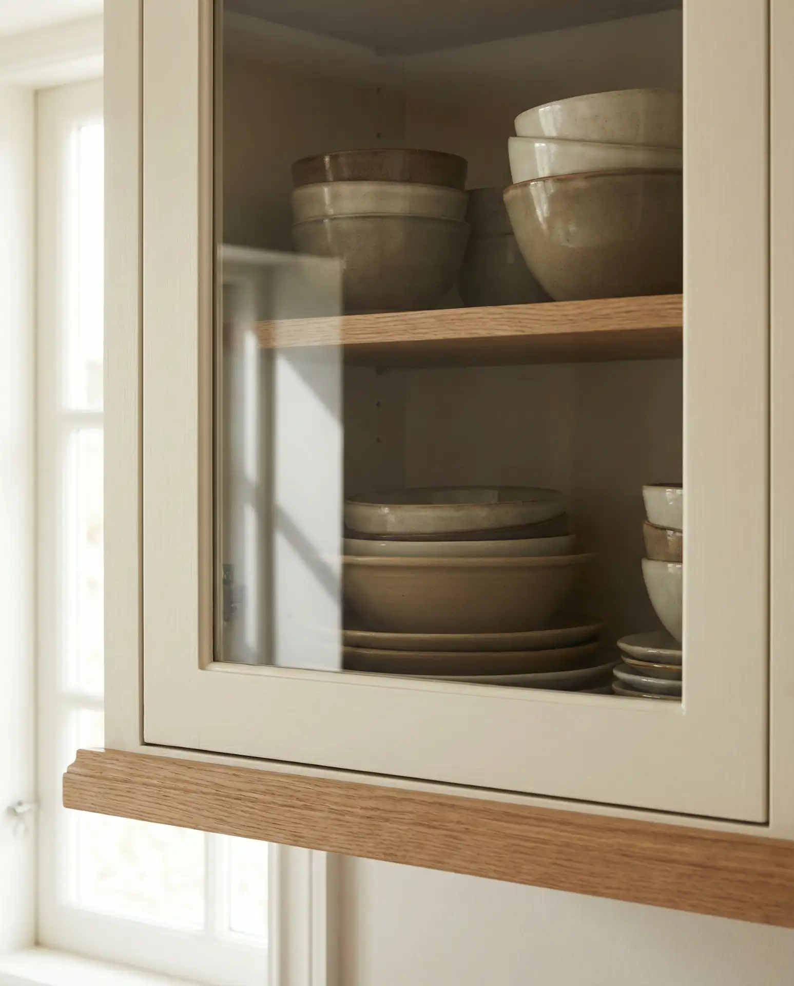 Neutral Painted Cabinets with Glass Fronts 1