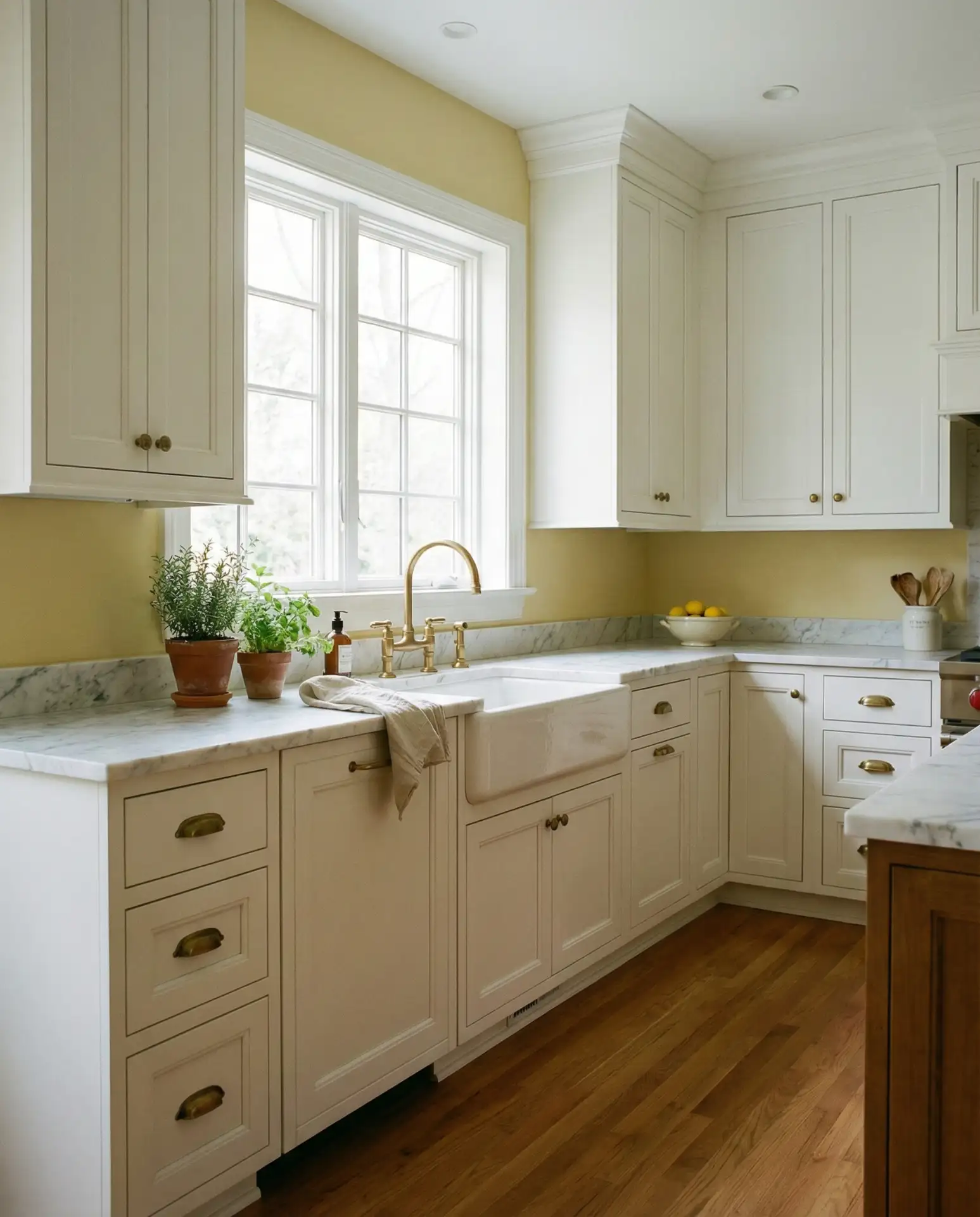 Yellow Walls with White Cabinets and Brass Details 1