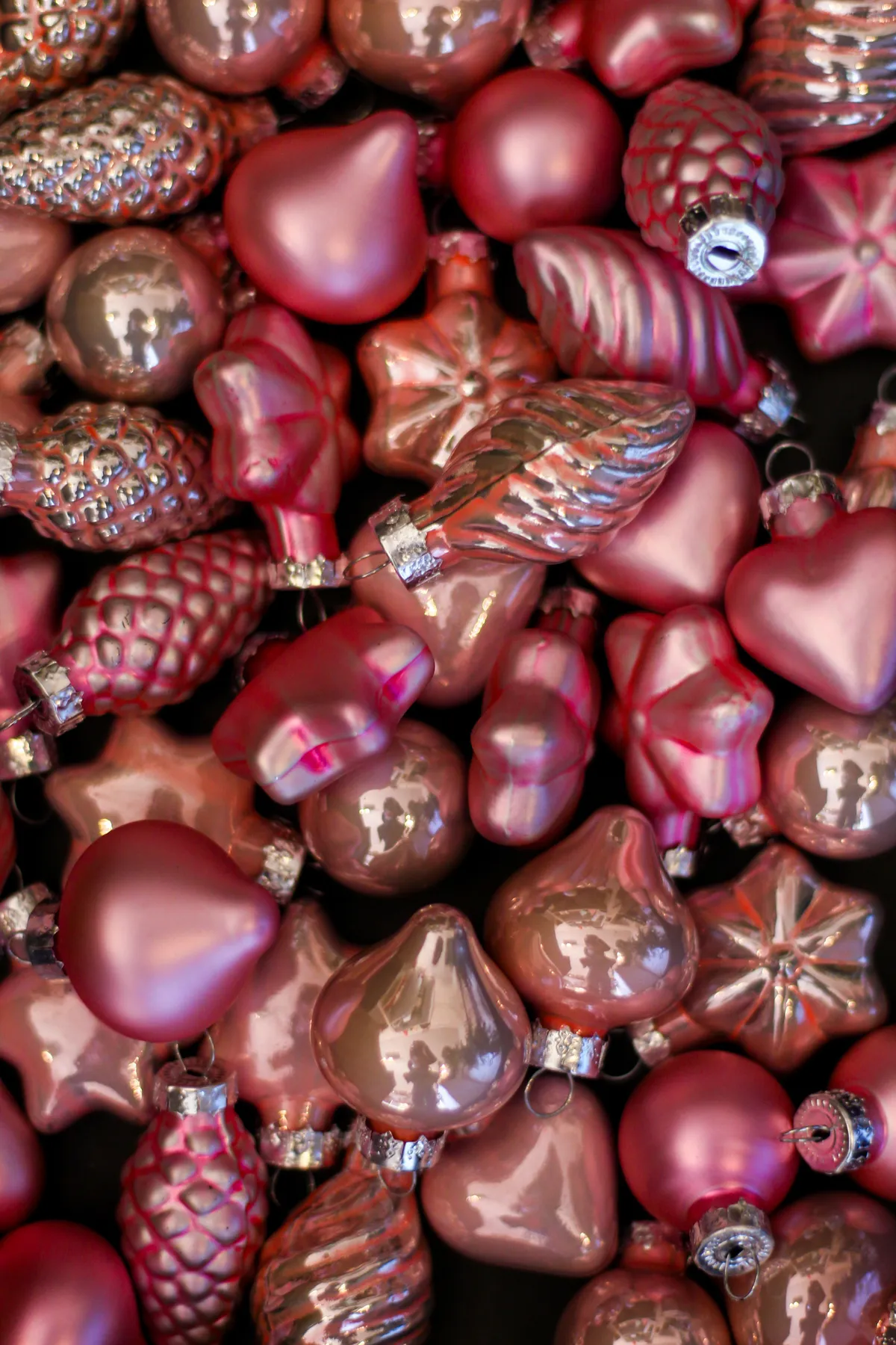 A colorful array of festive pink Christmas ornaments for holiday decoration.