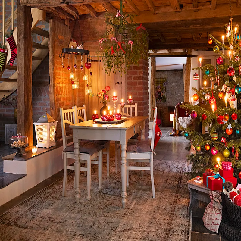 A decorated Christmas tree and a dining table in a rustic room | NJ Home