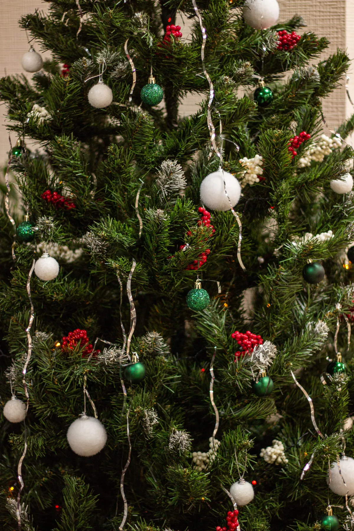 A decorated Christmas tree with ornaments and lights, capturing holiday spirit.