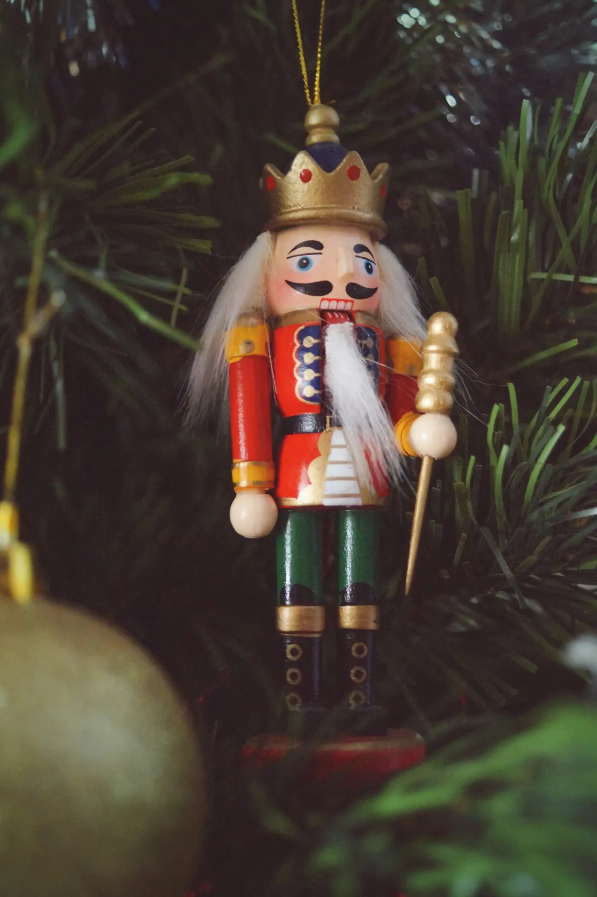 A nutcracker ornament hanging from a christmas tree - Free Photo on Unsplash