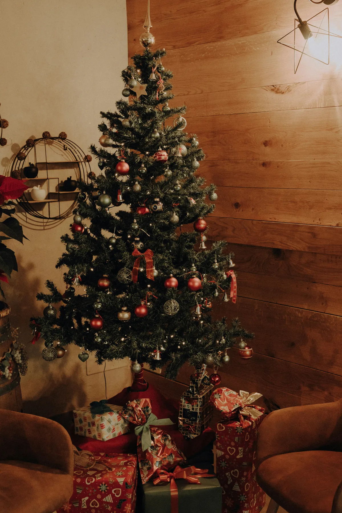 a small christmas tree with presents under it