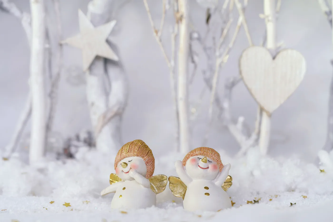 Adorable snow angels figures in a winter wonderland setting, perfect for seasonal decor.