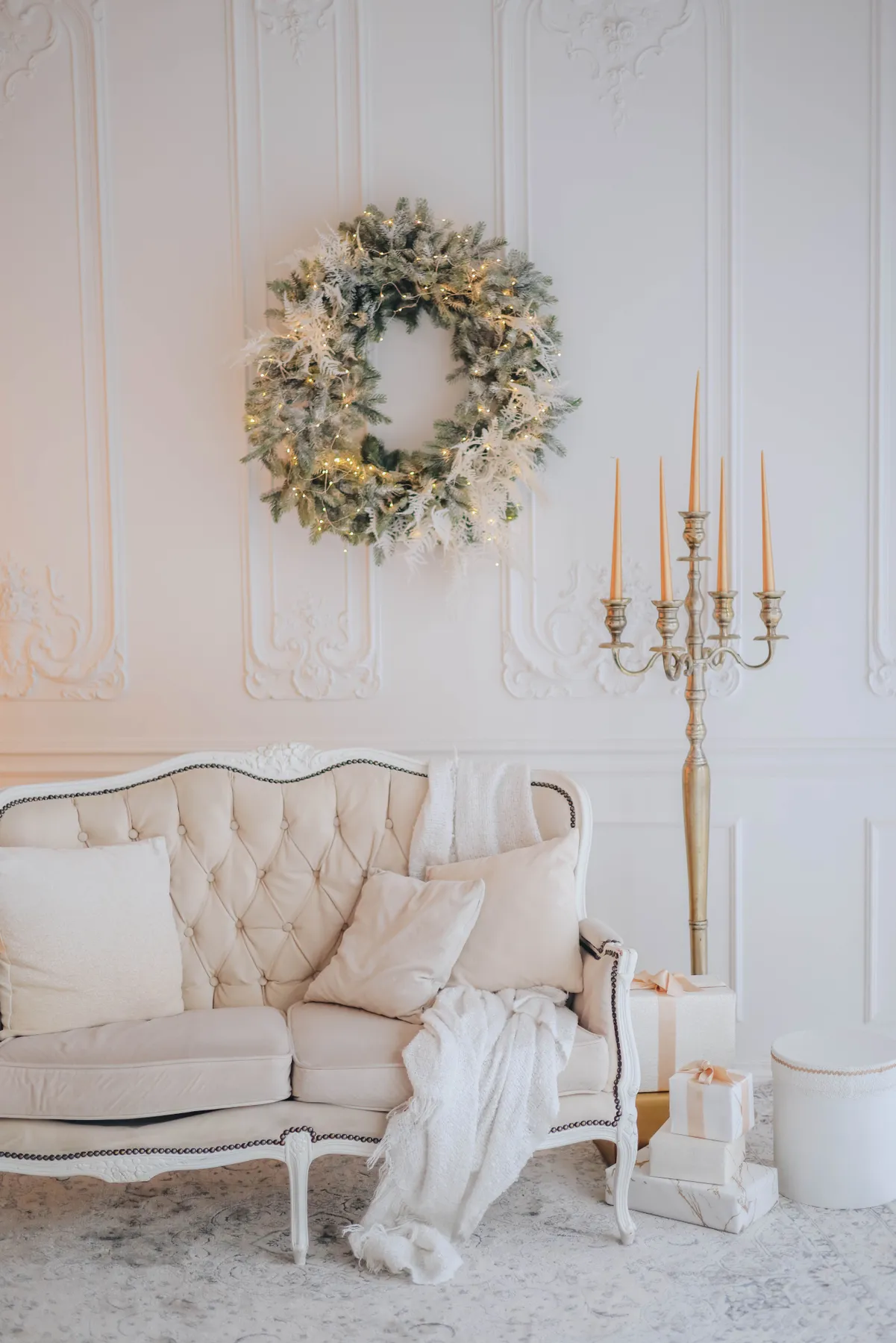 Beautiful living room with Christmas wreath, candles, and festive decor.