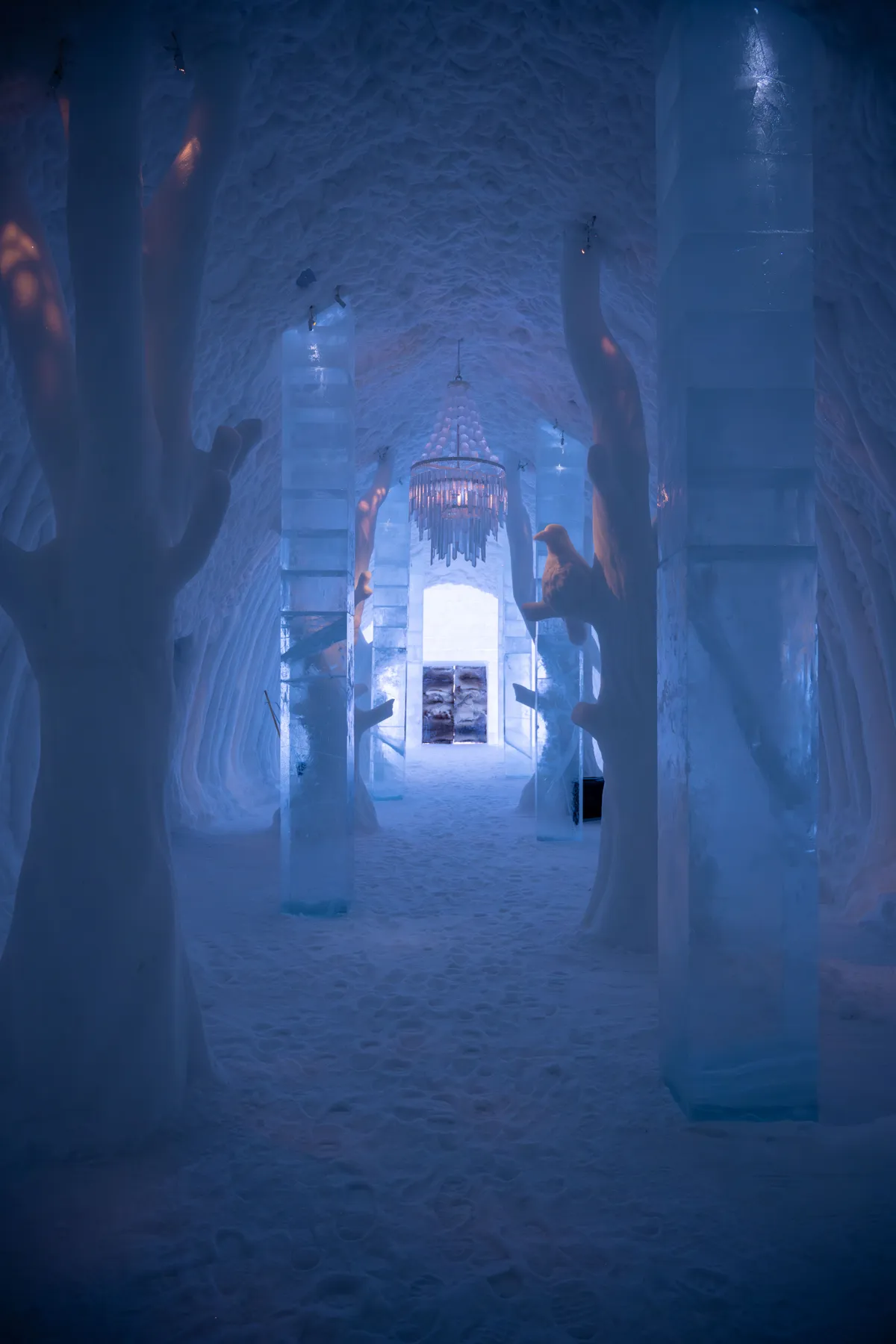 Captivating icy interior with sculpted pillars in an ice hotel in Kiruna, Sweden.