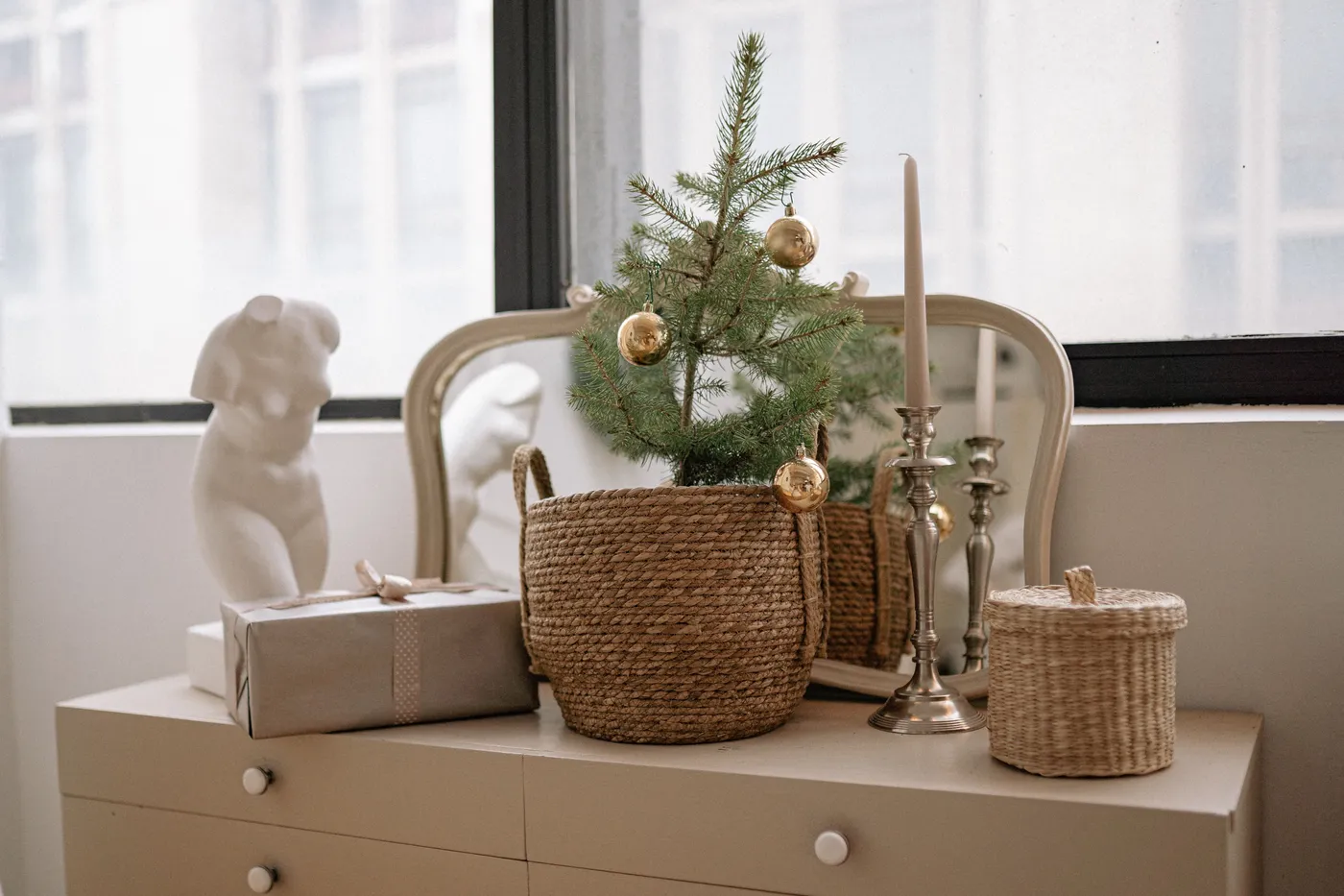 Charming holiday decor setup with a mini Christmas tree and stylish accents for a cozy atmosphere.