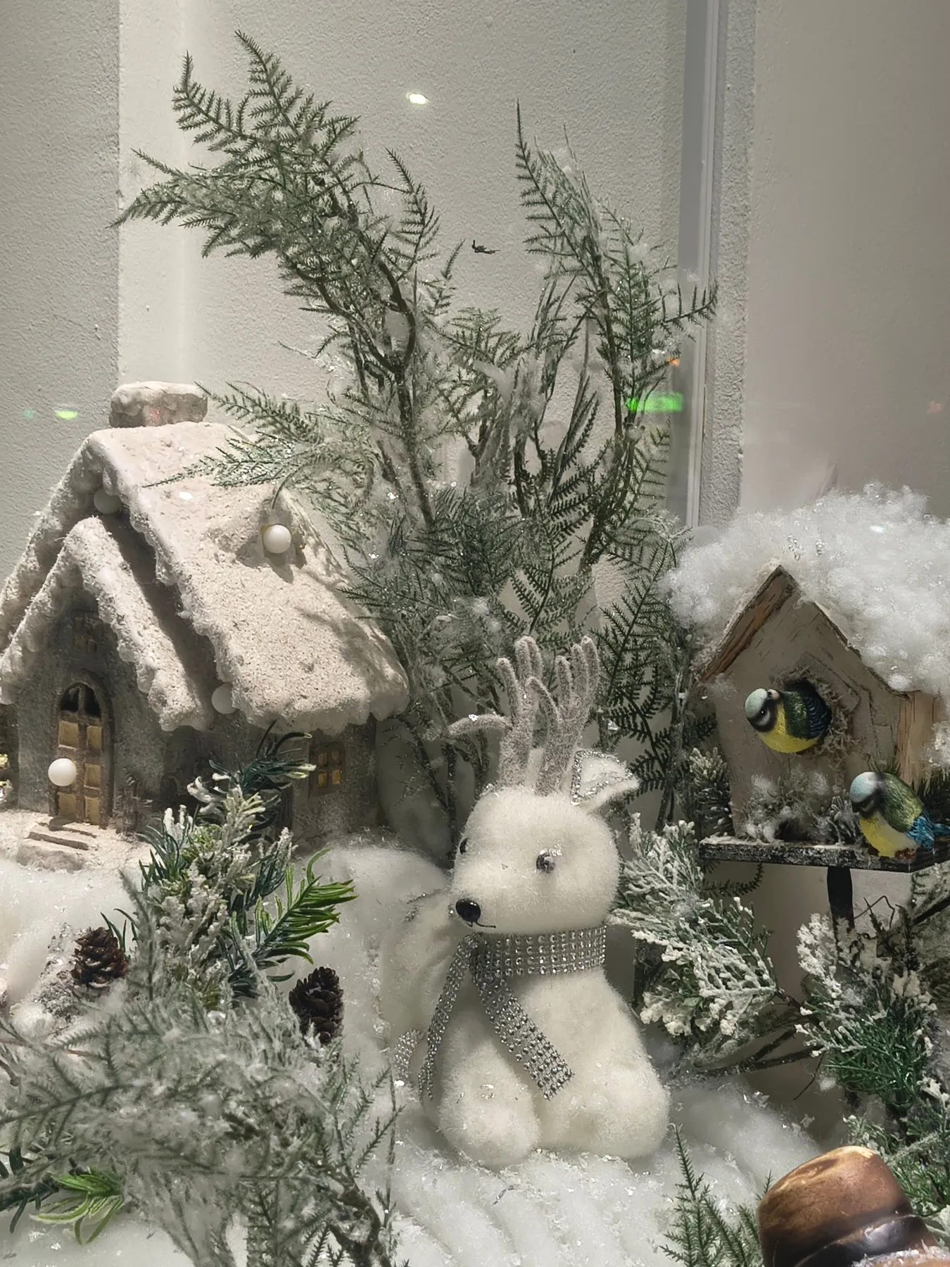 Charming winter display featuring snow-covered decorations, perfect for evoking Christmas spirit.