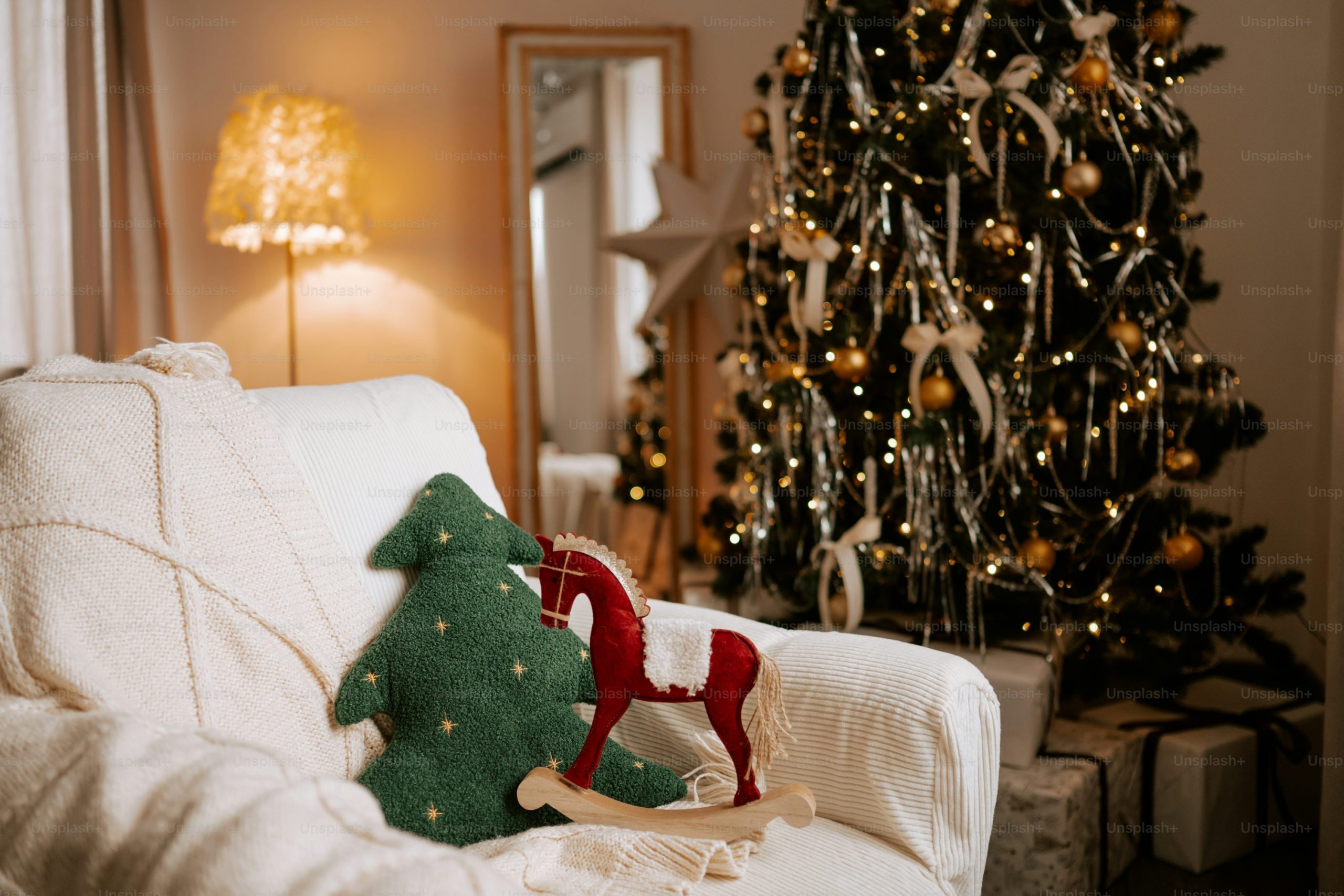 Cozy christmas living room with decorated tree and rocking horse - Photo on Unsplash+