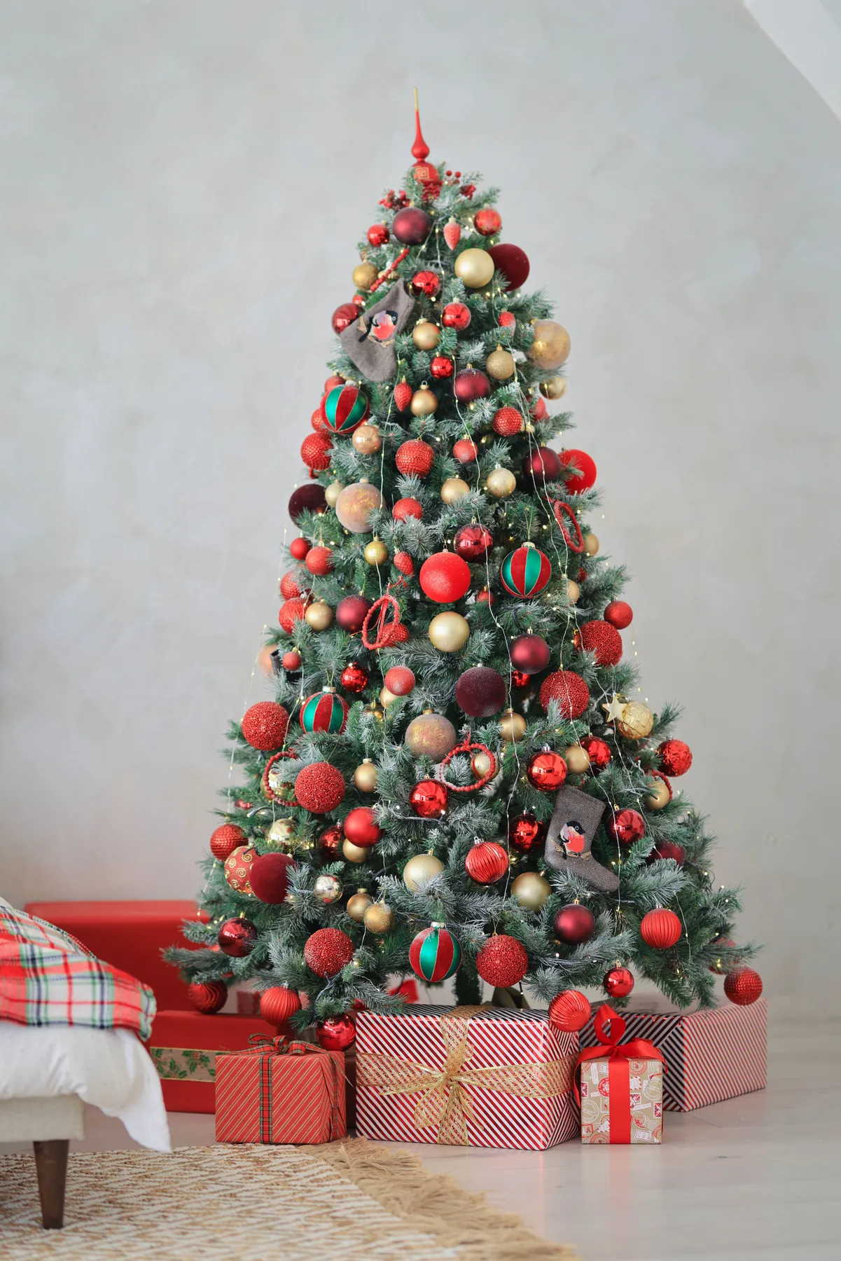 Decorated Christmas tree with baubles and wrapped presents for a festive holiday atmosphere.