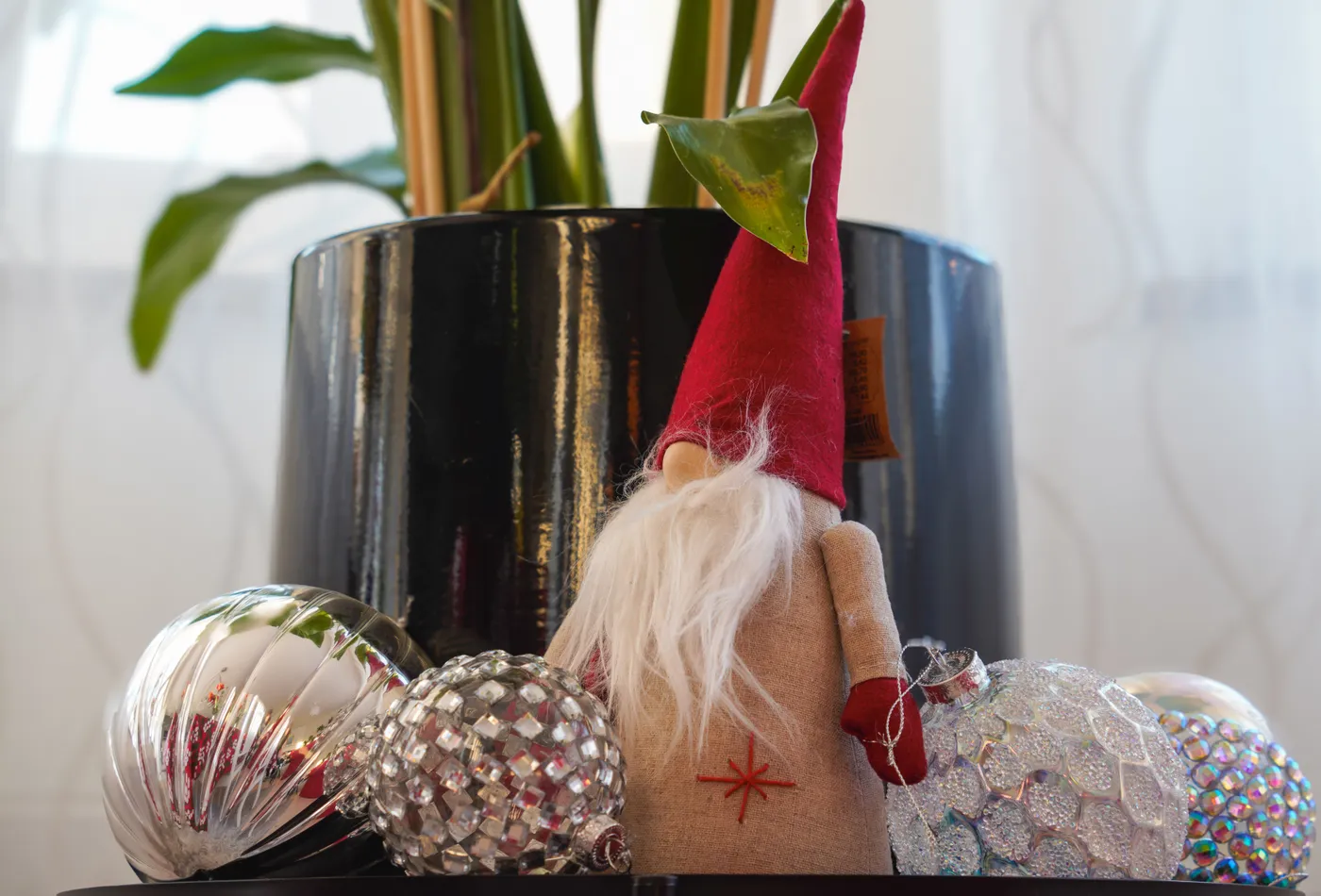 Decorative gnome and ornaments with potted plant, creating a festive ambiance indoors.