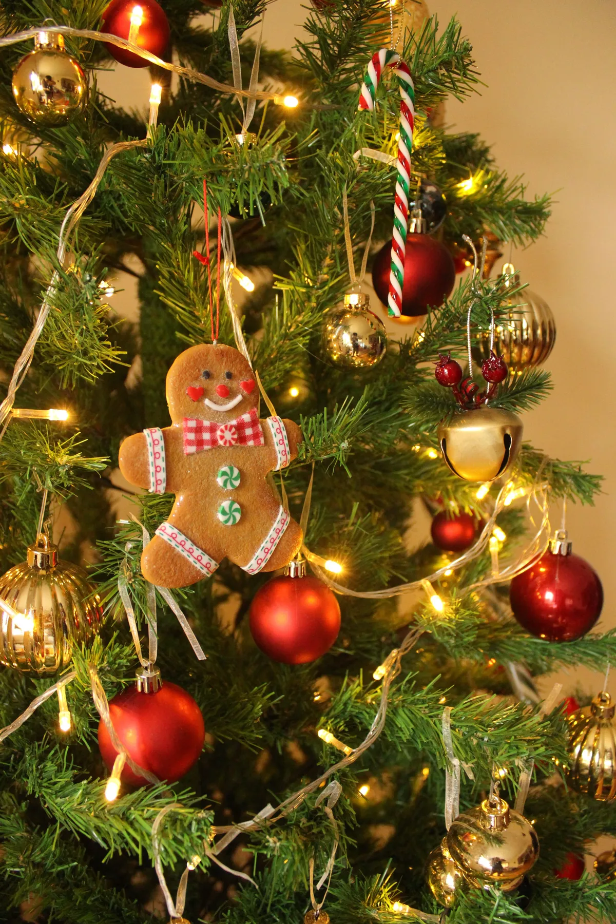 Festive Christmas tree with gingerbread ornament and lights creating a warm atmosphere.