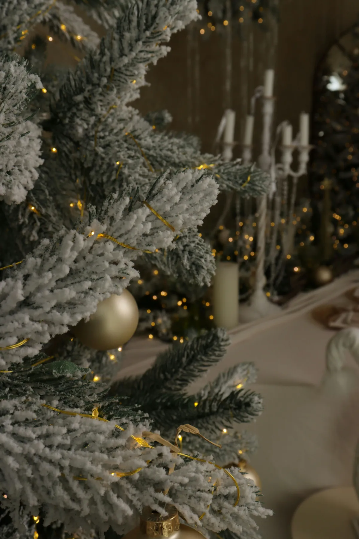 Frosted christmas tree with warm fairy lights