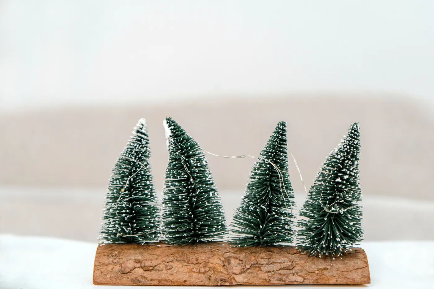 Handmade miniature Christmas trees on wood base, perfect for holiday decoration.