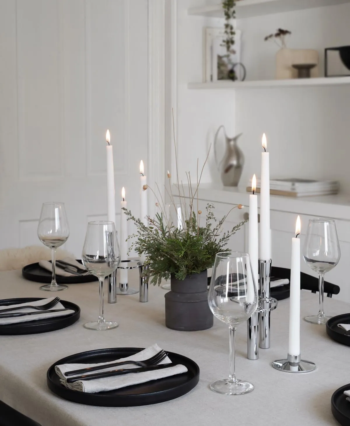 Minimalist Christmas table styling with festive foliage |