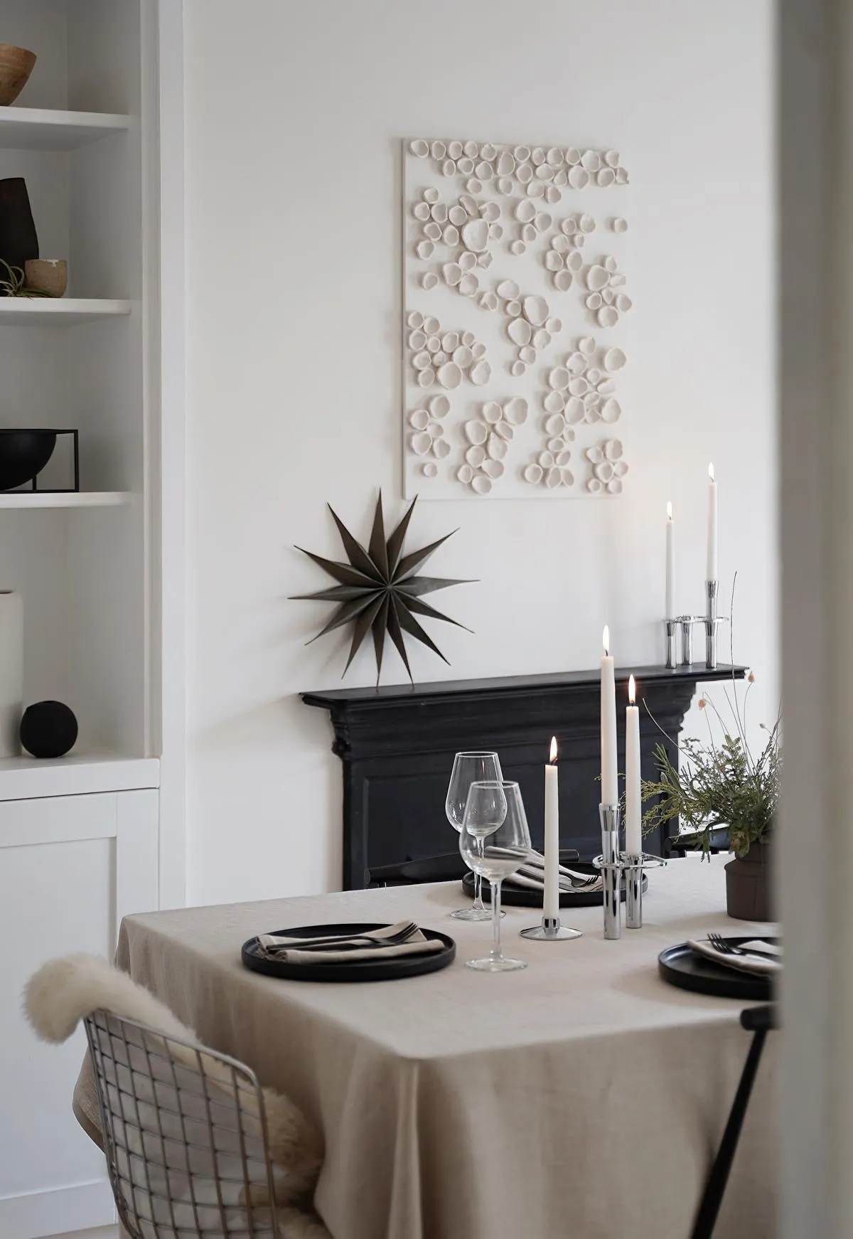 Minimalist Christmas table styling with festive foliage |