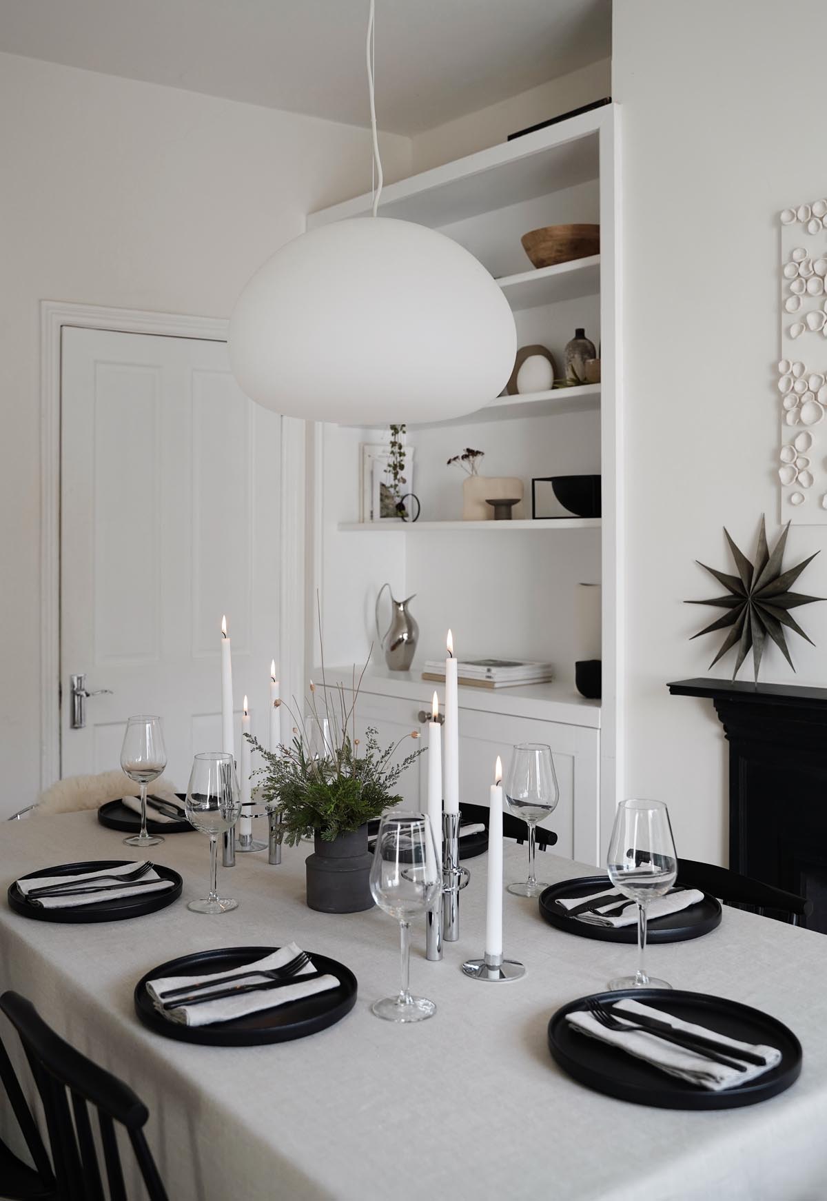 Minimalist Christmas table styling with festive foliage |