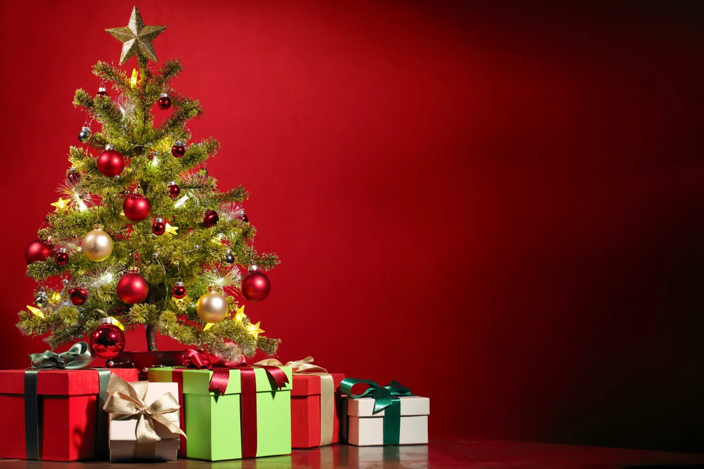 Royalty-Free photo: Green Christmas trees with assorted boxes | PickPik
