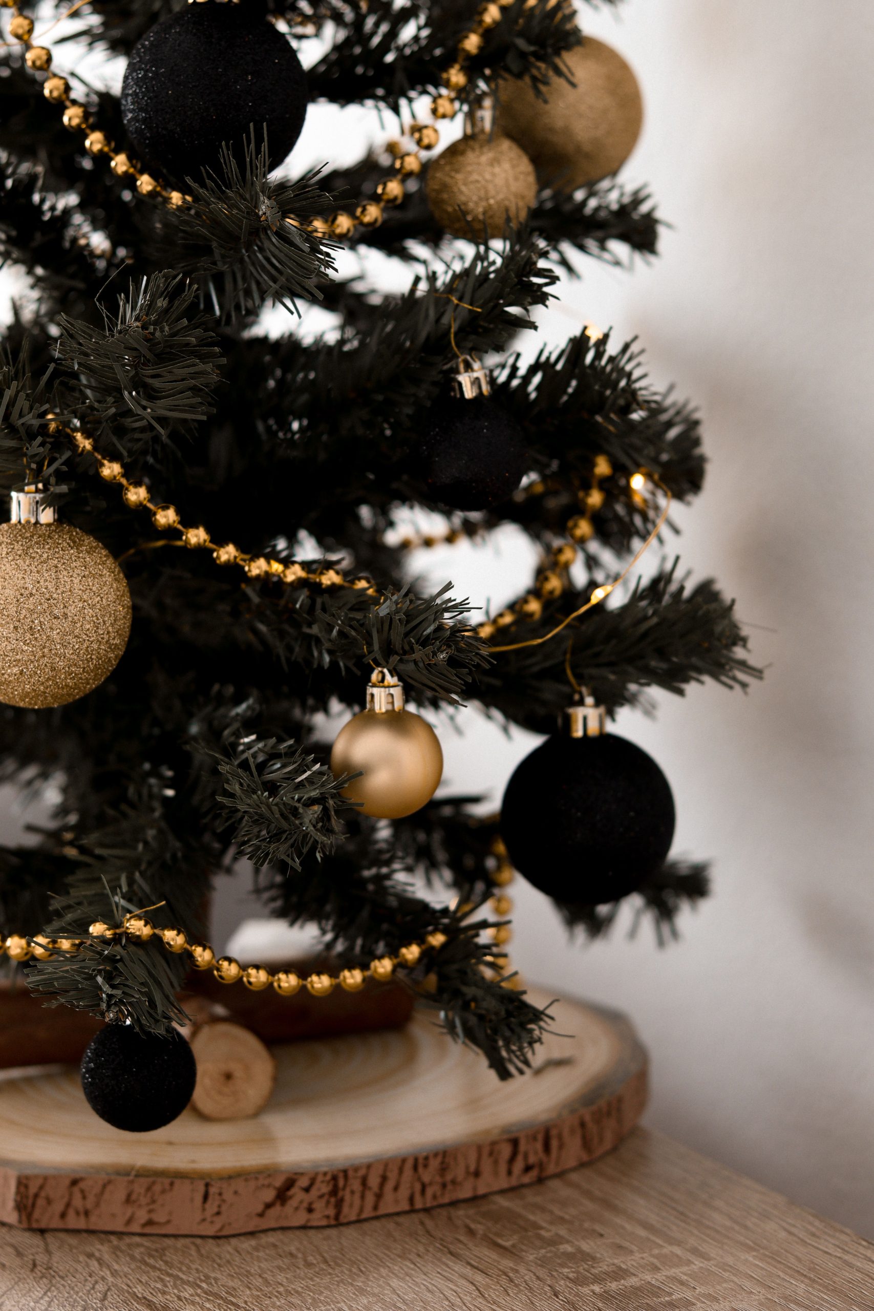 Stylish Christmas tree with black and gold ornaments, perfect for festive decor inspiration.