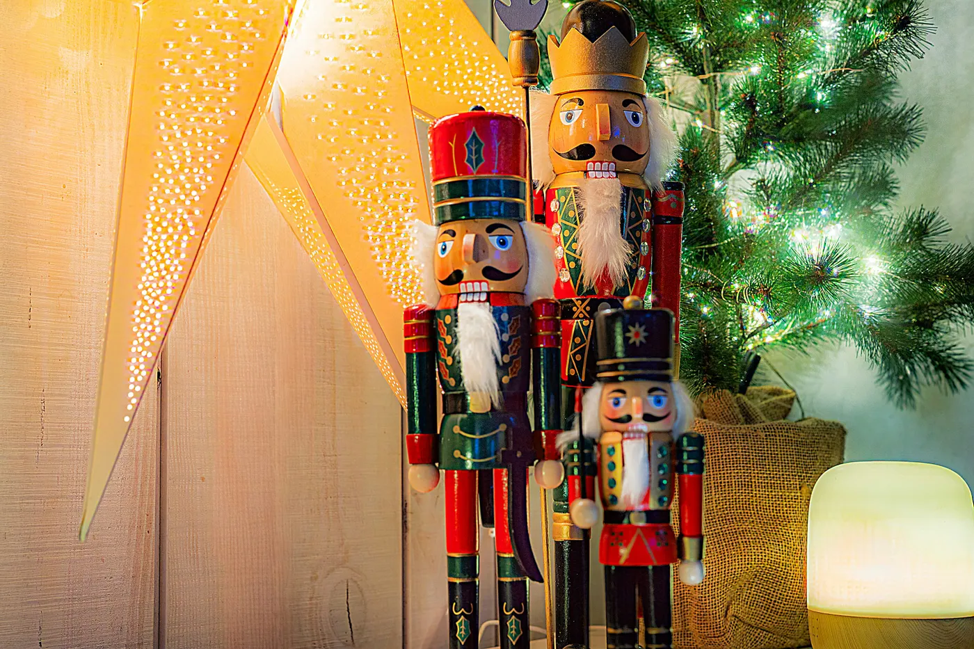 Three nutcracker figures stand by a christmas tree - Free Photo on Unsplash