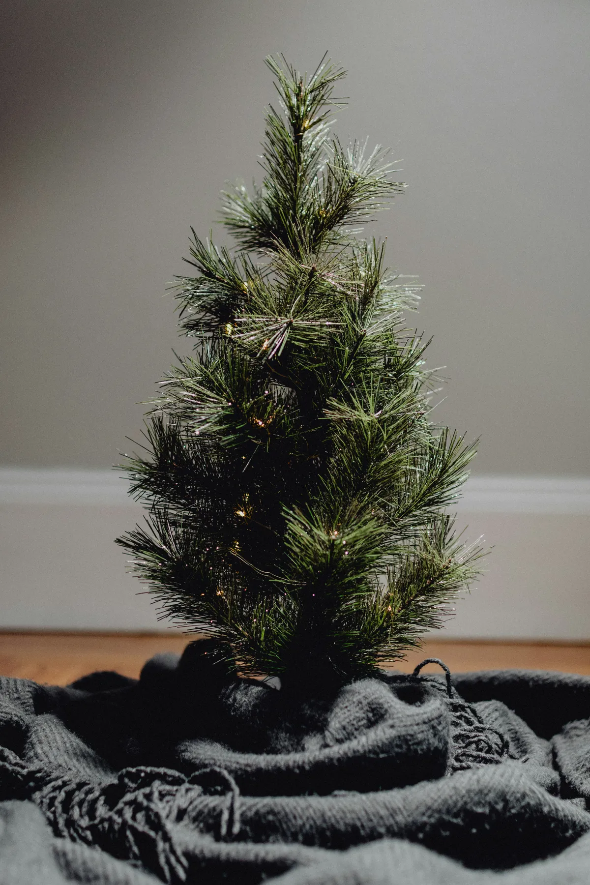 Tiny tree with a blanket as a tree skirt