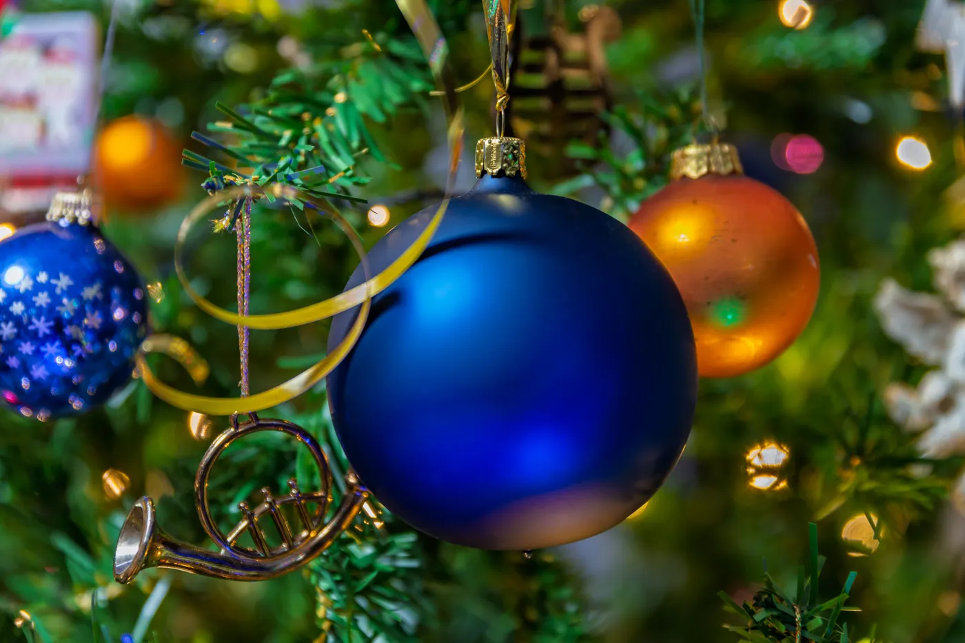 Vibrant Christmas ornaments on a decorated tree for holiday festivities.