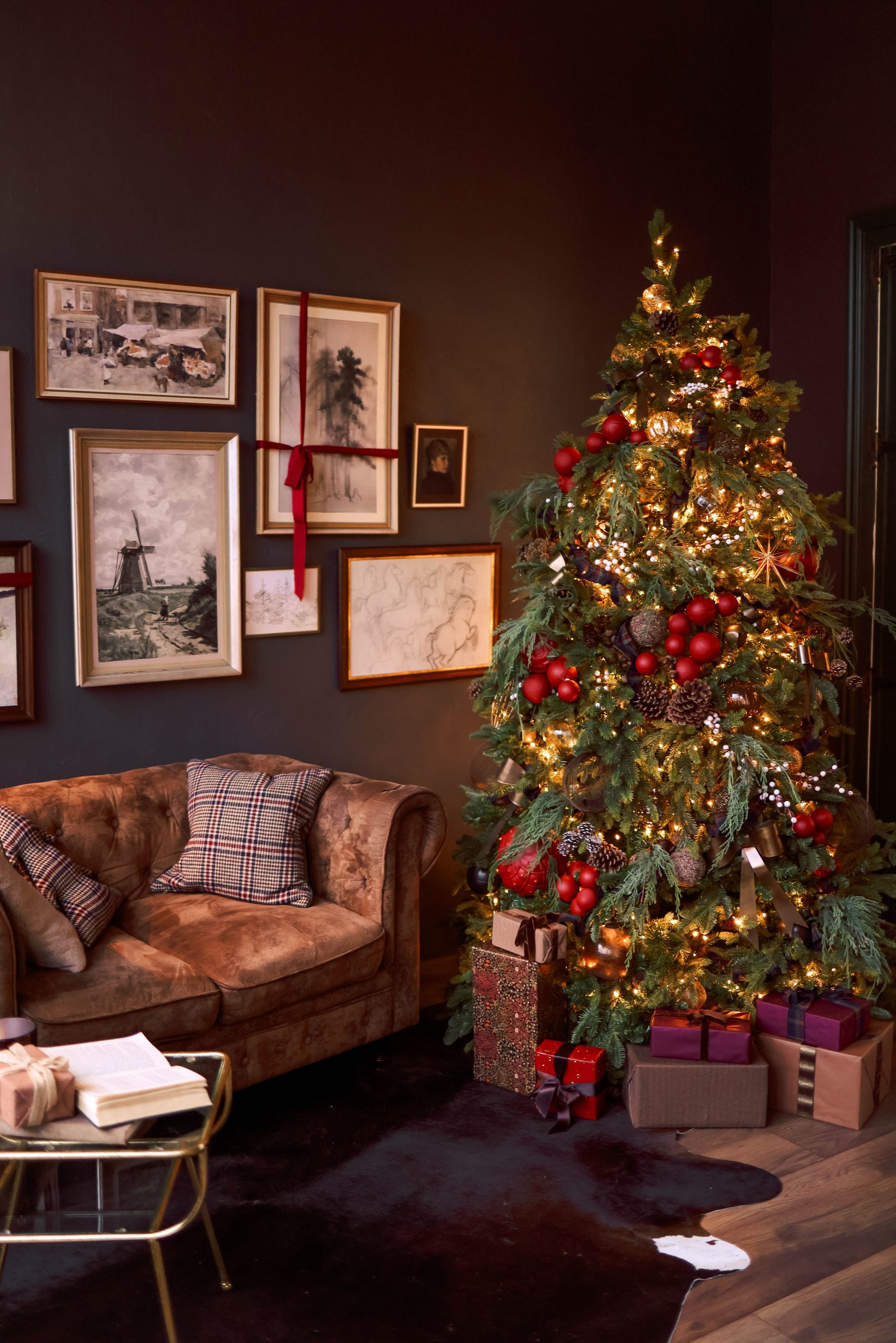 Warm festive living room with decorated Christmas tree and cozy seating area.